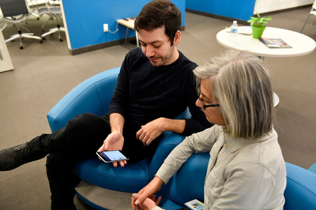 Stephen from uCarenet explains the app to an older adult. 