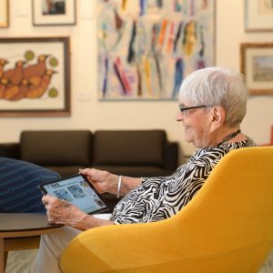 Woman sitting in a yellow chair