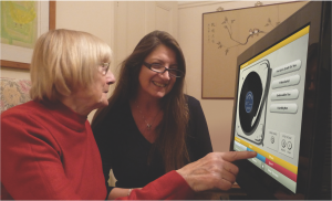 Older adult woman, and younger woman looking at a screen 