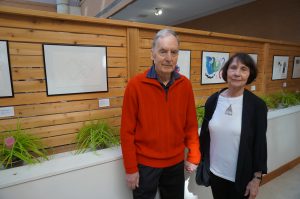 A picture of Diane, who's interviewed, and her husband at the art exhibit held at Baycrest