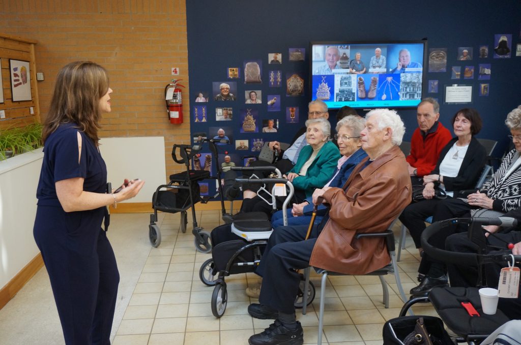 Renee Climans speaks to attendees at the Road to Connection exhibit