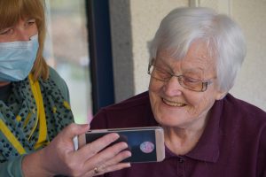 Smiling senior woman looking at a cellphone