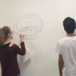 Students draw on the white board during a CABHI-hosted workshop to brainstorm innovations.