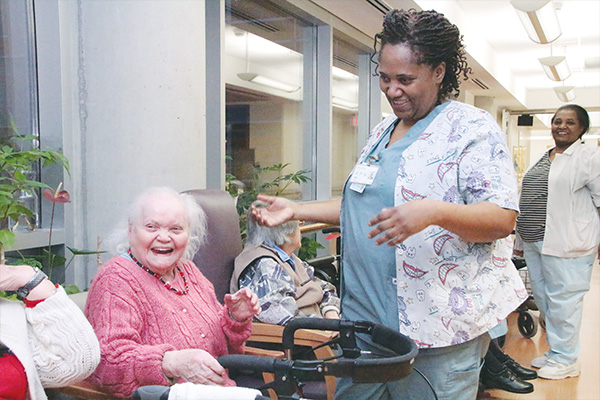 building-skilled-workforce image of elderly lady laughing with carer