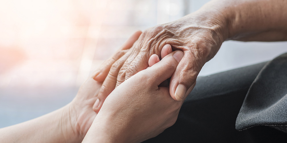 Holding hands, one younger and one older