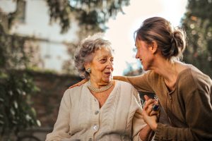 Young woman and senior woman looking at each other. 